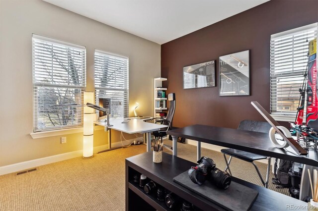 office featuring visible vents, light colored carpet, and baseboards