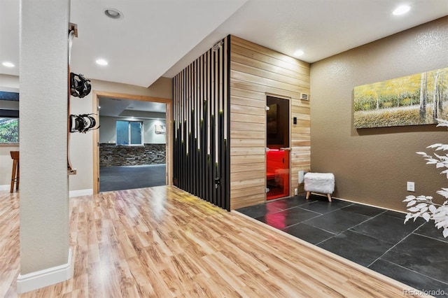 hall featuring recessed lighting, baseboards, and wood finished floors