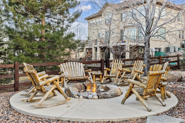 view of patio / terrace with fence and an outdoor fire pit