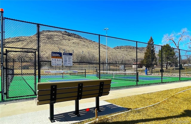 surrounding community featuring a tennis court and fence