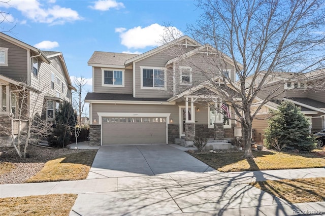 craftsman-style house featuring stone siding, concrete driveway, and an attached garage