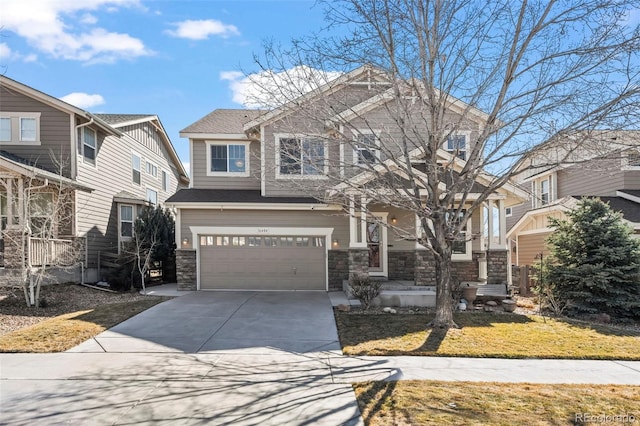 craftsman-style house featuring a front lawn, roof with shingles, a garage, stone siding, and driveway