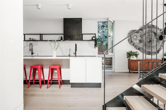 kitchen featuring light wood-style flooring and a sink