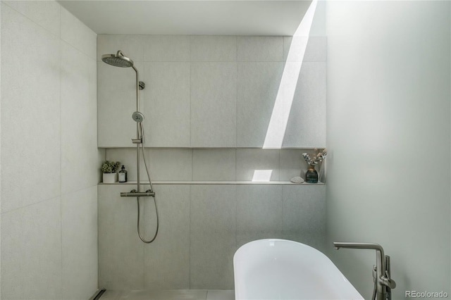 bathroom with tiled shower and a freestanding bath