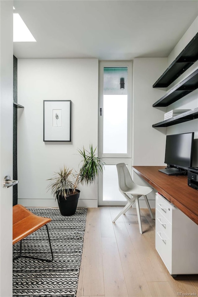 home office with light wood finished floors