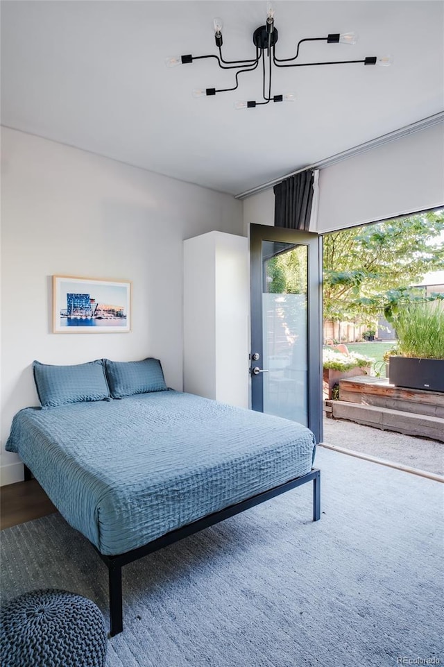 bedroom with a notable chandelier and multiple windows