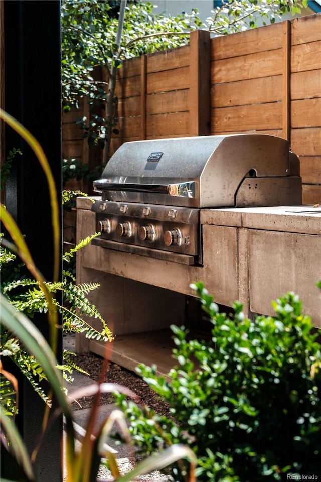 view of patio / terrace with fence and a grill