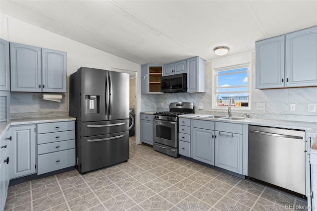7855 Edison Rd, Yoder, CO 80864 - kitchen featuring stainless steel appliances, decorative backsplash, lofted ceiling, light countertops, and open shelves
