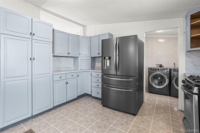7855 Edison Rd, Yoder, CO 80864 - kitchen featuring stainless steel appliances, washer and dryer, and light countertops