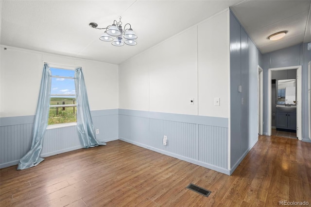 7855 Edison Rd, Yoder, CO 80864 - unfurnished dining area with wood finished floors, a chandelier, and wainscoting
