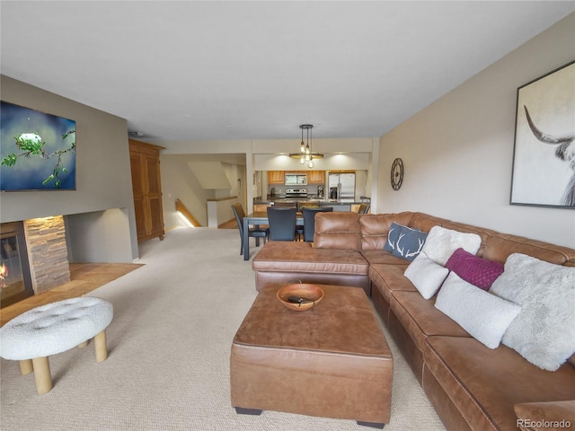 living room featuring light colored carpet and a fireplace