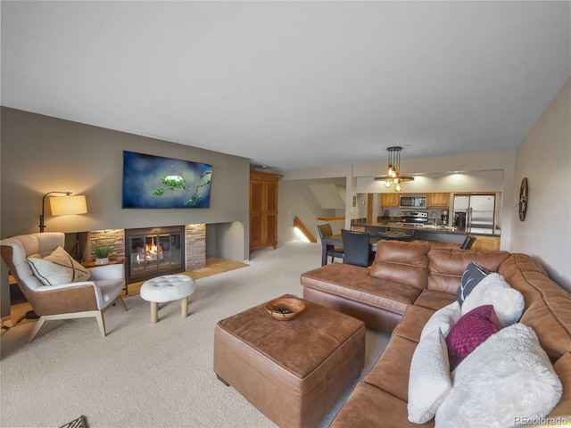 living room featuring a stone fireplace and light carpet