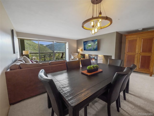 dining room featuring light carpet and a notable chandelier