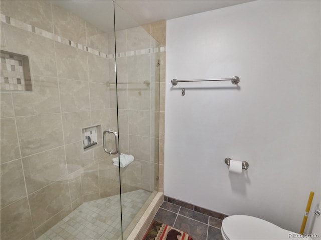 bathroom with walk in shower, toilet, and tile patterned flooring