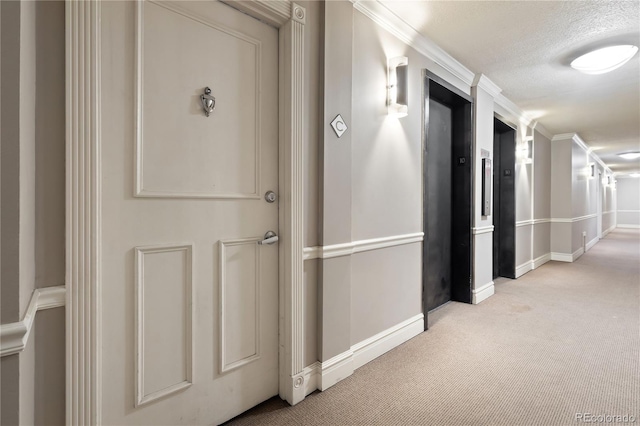 hallway with baseboards, elevator, a textured ceiling, crown molding, and carpet flooring