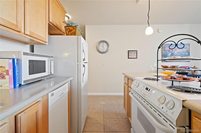 kitchen with light brown cabinets, decorative light fixtures, white appliances, light tile patterned flooring, and light countertops