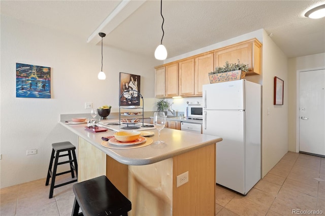 kitchen with light tile patterned floors, white appliances, a peninsula, and light brown cabinetry