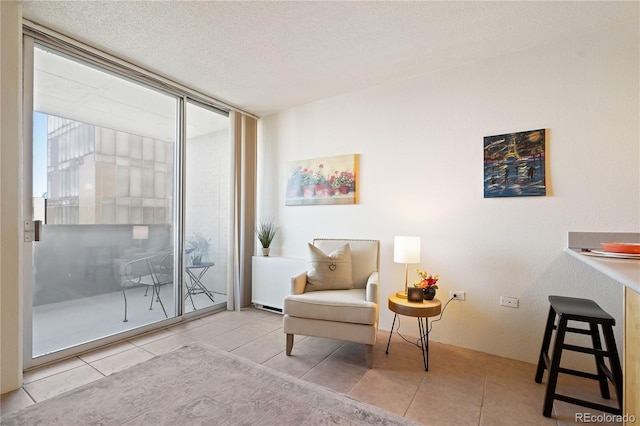 sitting room featuring a textured ceiling and tile patterned flooring