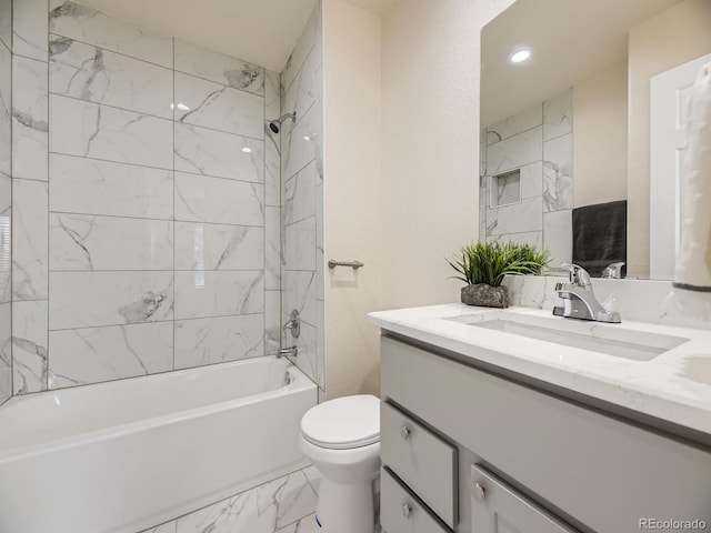 full bathroom with vanity, toilet, and tiled shower / bath combo