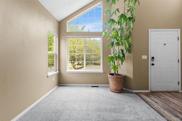 429 Arrowhead Dr, Loveland, CO 80537 - entrance foyer featuring a textured wall, vaulted ceiling, baseboards, and carpet floors
