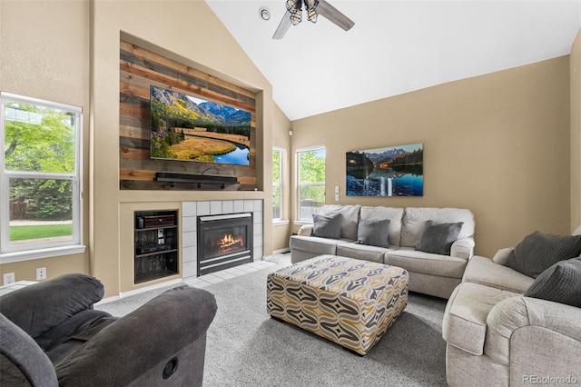 429 Arrowhead Dr, Loveland, CO 80537 - living area featuring carpet floors, a ceiling fan, a tiled fireplace, and high vaulted ceiling