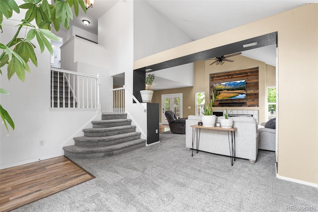 429 Arrowhead Dr, Loveland, CO 80537 - carpeted living room with stairway, ceiling fan, baseboards, high vaulted ceiling, and wood finished floors