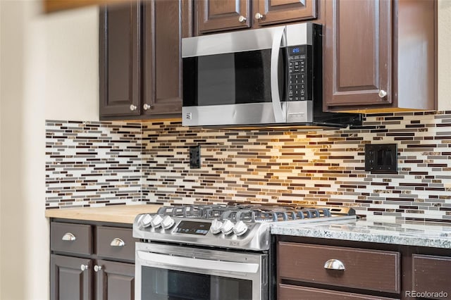 429 Arrowhead Dr, Loveland, CO 80537 - kitchen with appliances with stainless steel finishes, dark brown cabinets, light countertops, and tasteful backsplash