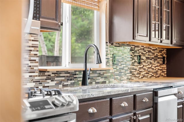429 Arrowhead Dr, Loveland, CO 80537 - kitchen with dark brown cabinets, backsplash, stove, and dishwasher