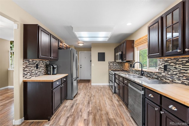 429 Arrowhead Dr, Loveland, CO 80537 - kitchen with a sink, appliances with stainless steel finishes, wooden counters, and tasteful backsplash