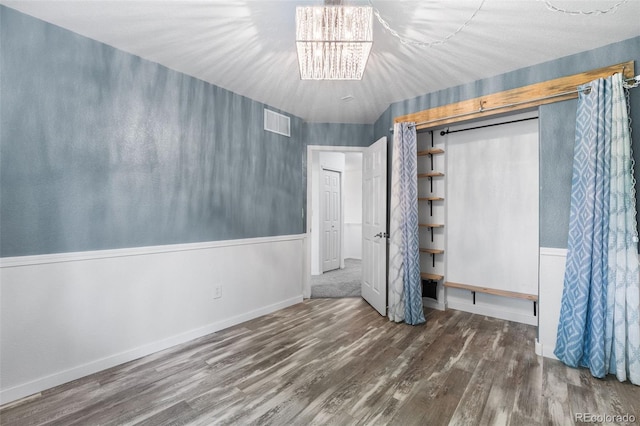 429 Arrowhead Dr, Loveland, CO 80537 - unfurnished bedroom featuring wood finished floors, a chandelier, and baseboards