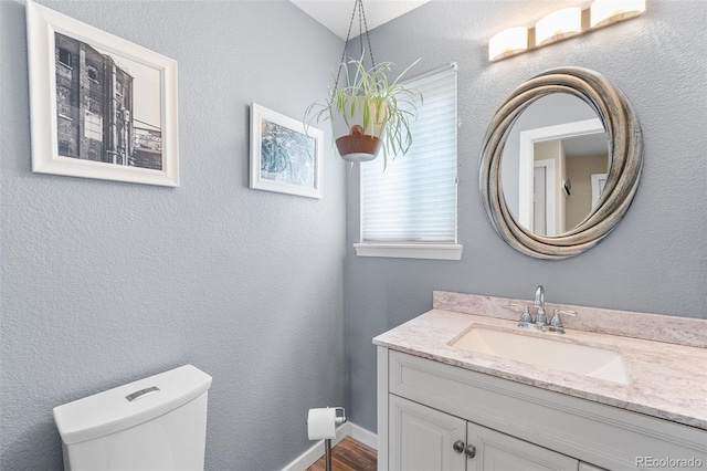 429 Arrowhead Dr, Loveland, CO 80537 - bathroom with toilet, wood finished floors, and vanity