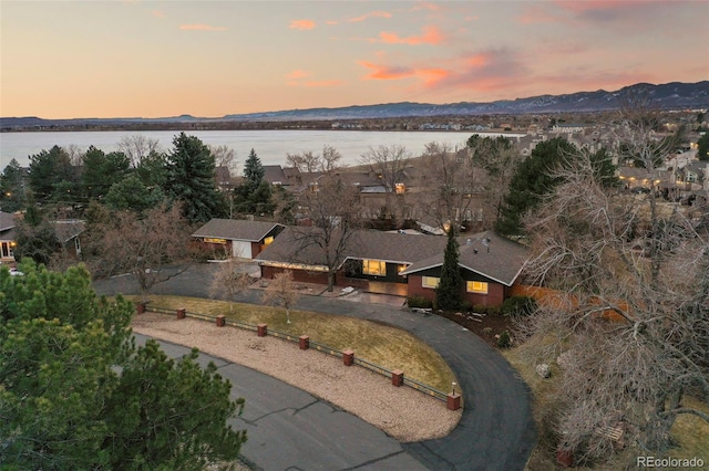 birds eye view of property with a water and mountain view