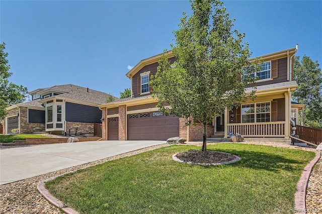 view of front of property with a front yard, a porch, and a garage