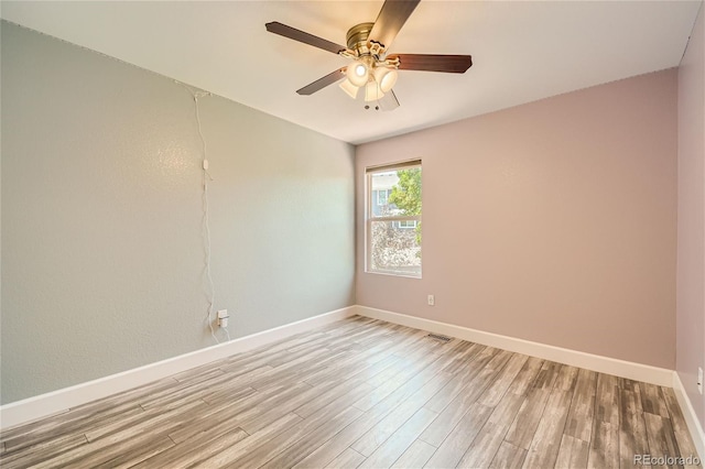 spare room with ceiling fan and light hardwood / wood-style floors