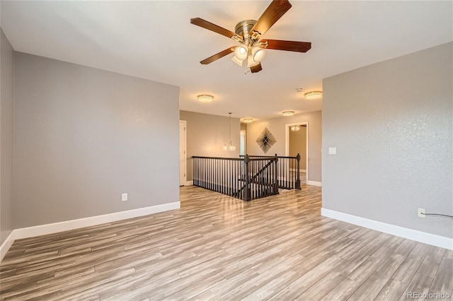 unfurnished room with light wood-type flooring and ceiling fan