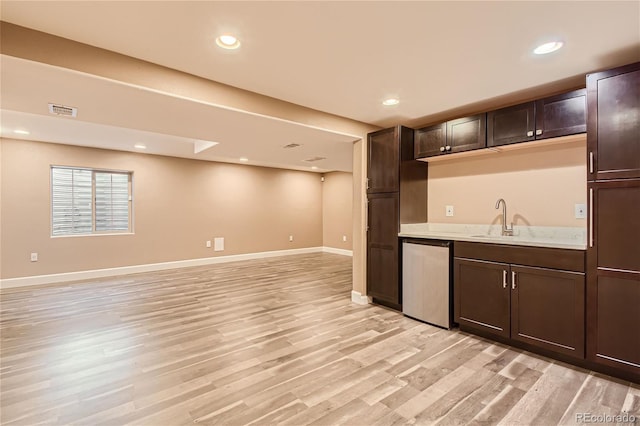 kitchen featuring sink, dark brown cabinets, light wood-type flooring, and dishwasher