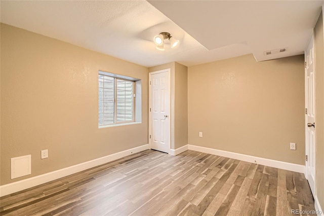 spare room featuring light hardwood / wood-style flooring