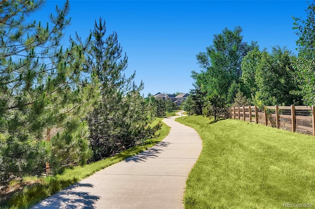 view of property's community with a lawn