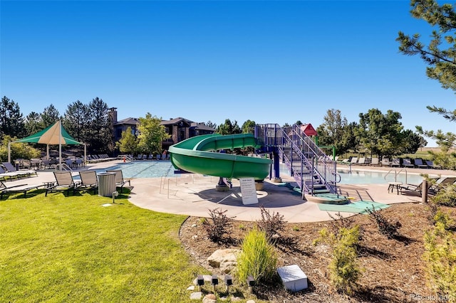 view of play area with a yard and a community pool