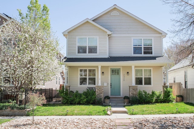 craftsman house featuring fence, a shingled roof, and a front yard