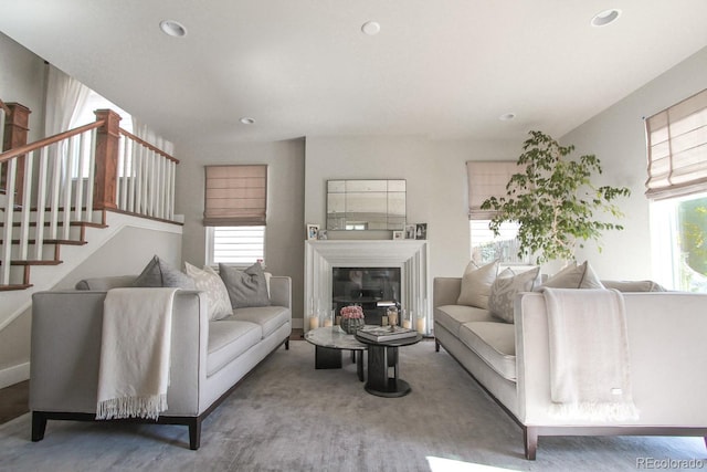 living room with recessed lighting, a healthy amount of sunlight, and stairway
