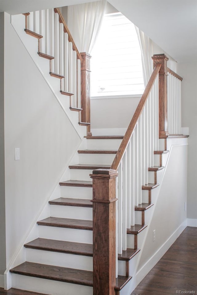 stairs featuring baseboards and wood finished floors