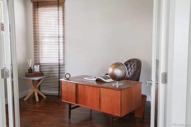 office area with baseboards, dark wood finished floors, and a wealth of natural light