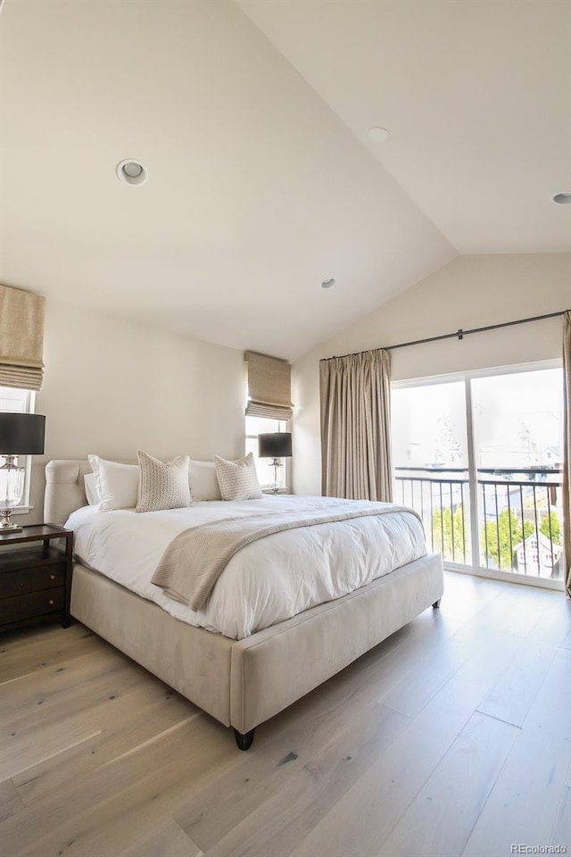 bedroom featuring access to outside, vaulted ceiling, and light wood-style flooring