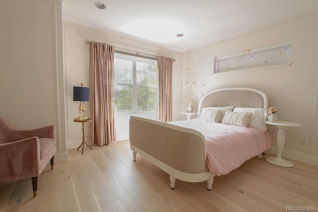 bedroom featuring baseboards and light wood-style flooring