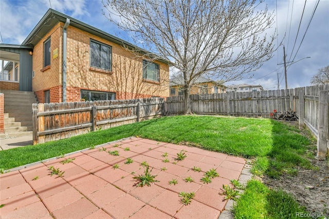 view of yard featuring a patio and a fenced backyard