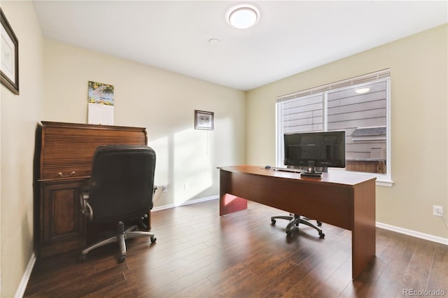 office with dark wood-type flooring and a healthy amount of sunlight