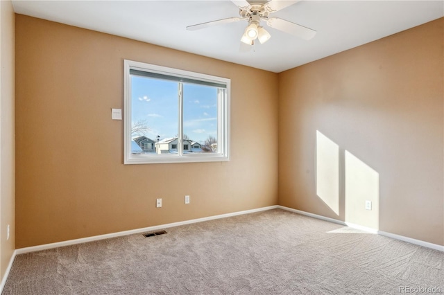 carpeted empty room featuring ceiling fan