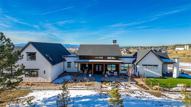 snow covered house with covered porch