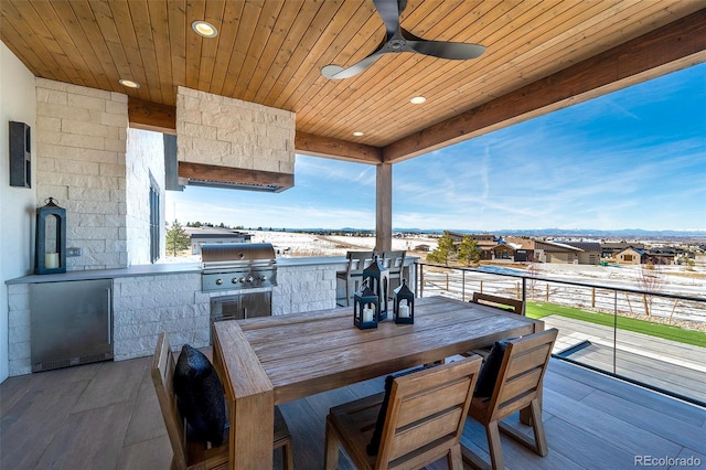 view of patio featuring area for grilling, ceiling fan, and an outdoor kitchen